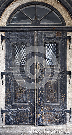 Wooden old door. Historical house door. Rural entry architecture element. Stock Photo