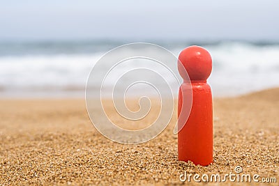 Wooden one, alone figure of red, dark color of man on the sand of beach with sea view. Concept of vacation. individual traveller. Stock Photo