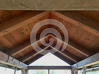 Wooden outdoor symmetrical roof construction Stock Photo