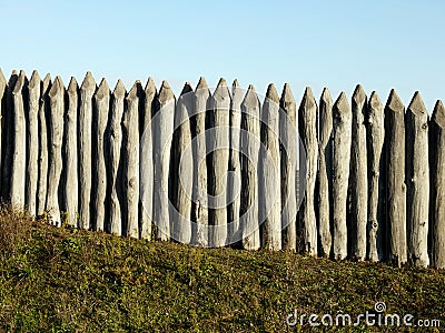 Wooden palisade of the protective fence Stock Photo
