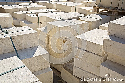 Wooden pallet of new travertine stone slabs ready to be mounted in a new pavement in a urban construction site Stock Photo