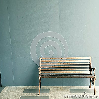 Wooden park chair indoor with blue wall colors Stock Photo