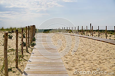 Wooden path coast access with sand beach waves entrance to ocean atlantic sea Stock Photo