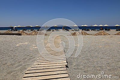 Wooden path to the sandy beach, Greece Stock Photo