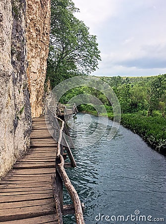 Wooden pathway over the river in the spring Stock Photo