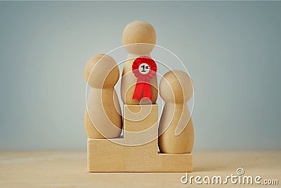 Wooden pawns standing on winner podium - Concept of winning and competition Stock Photo