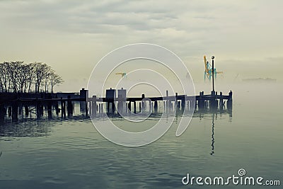 Wooden peer in fog Stock Photo