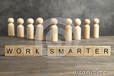 Wooden peg doll with a row of wooden cubes with 'work smarter' text Stock Photo