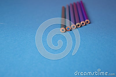 Wooden pencils of different shades of blue on a blue background Stock Photo