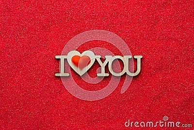 Wooden phrase I heart you on red sand top view Stock Photo