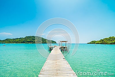 Wooden pier or bridge with tropical beach and sea in paradise is Editorial Stock Photo