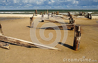 Wooden pier destroyed by storm. Stock Photo