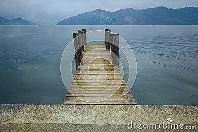 Wooden pier on lake. Vacation, tourism and adventure concept. Retro filter Stock Photo