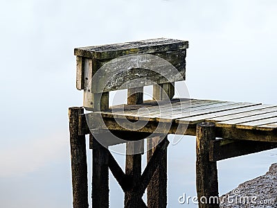 Wooden pier with pilings over milky water Stock Photo