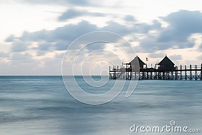 Wooden pier at sunrise, Zanzibar island Stock Photo