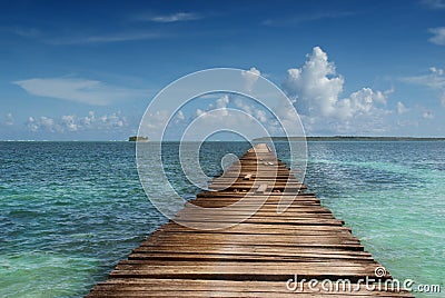 Wooden pier in tropical sea Stock Photo