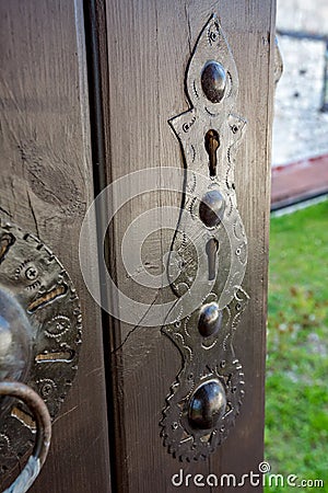 Wooden door, metallic escutcheon, brown painted Stock Photo