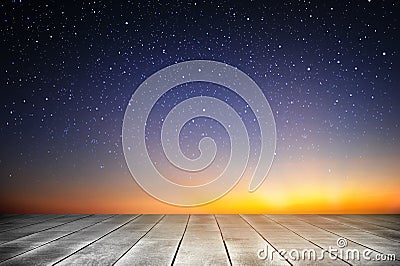Wooden plank and starry night background in the sunrise time Stock Photo