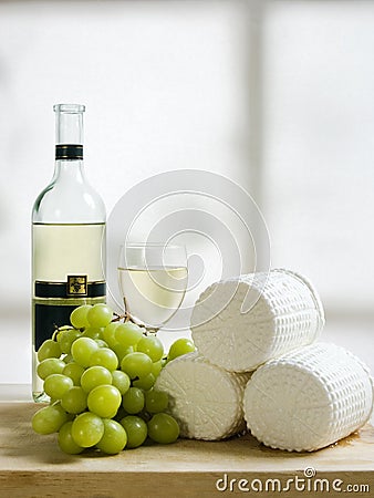 Wooden plate of cheese grapes and wine Stock Photo