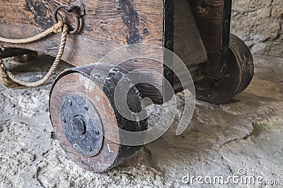 Wooden platform with wheels on which a medieval cannon is installed Stock Photo