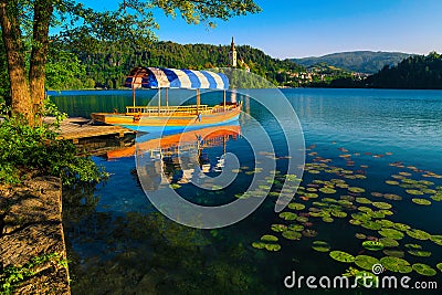 Wooden Pletna boat moored at the pier, lake Bled, Slovenia Stock Photo