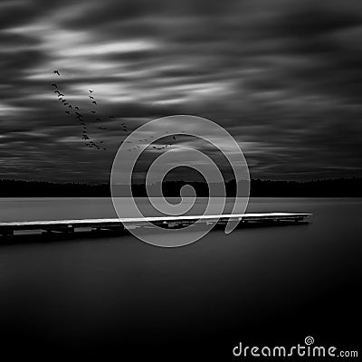 Wooden posts in a lake, long time exposure Stock Photo