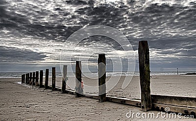 Wooden posts at the seashore in northern Wales Stock Photo