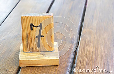 Wooden priority number 7 on a plank tab Stock Photo