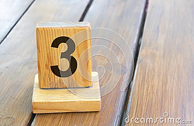 Wooden priority number 3 on a plank tab Stock Photo