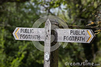 A wooden public footpath sign on a country path Editorial Stock Photo