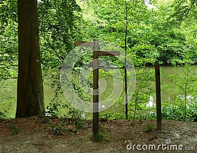 Wooden Public Footpath Sign by a forest lake Stock Photo