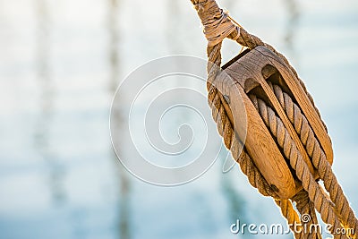 Wooden pulley with nautical ropes of traditional sailboat Stock Photo