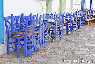 Wooden purple chairs at Ano Koufonisi island Cyclades Greece Stock Photo