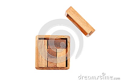 A wooden puzzle is a cube. Isolated on white background. Close-up. Stock Photo