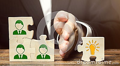 Wooden puzzles with icons of employees and business idea. Concept of new ideas and discoveries. Cooperation teamwork. Achieving Stock Photo