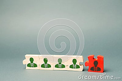 Wooden puzzles with the image of workers. The concept of personnel management in the company. Dismissing an employees from a team Stock Photo