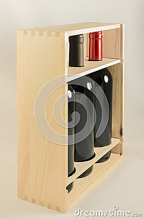 Wooden rack with three wine bottles Stock Photo