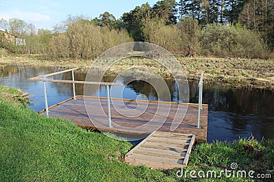 Wooden raft on the river for rinsing clothes Stock Photo