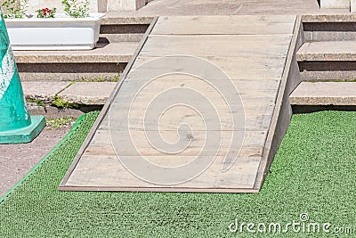 Wooden ramped access, using wheelchair ramp for disabled people. Stock Photo