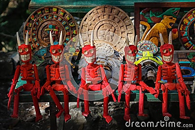 Wooden red figurines of skeletons. Traditional Mexican souvenirs. Stock Photo