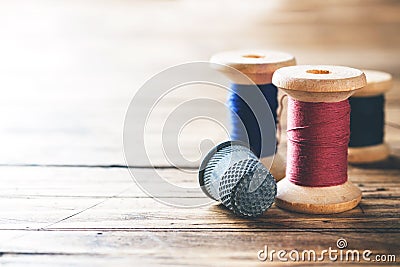 Wooden reel with thread and fingertip close-up. Selective focus. Rendered image. Copy space Stock Photo