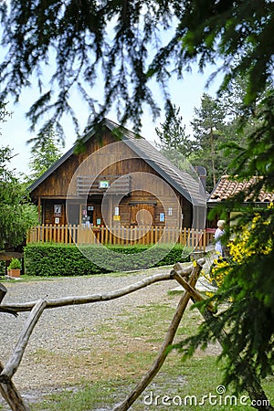 wooden refuge building across the fir-tree branches. Rural life. Vacation in the countryside. Monte Fuso, Parma Stock Photo