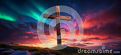 wooden religious cross on the hill with beautiful northern lights and sunset Stock Photo