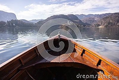 Wooden rent boat on a Bled lake, end of the boat facing towards Lake Bled island with copy space- famous tourist Stock Photo