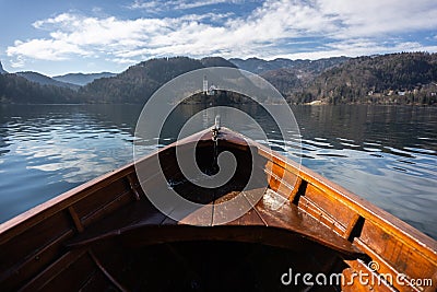 Wooden rent boat, end of the boat facing towards Lake Bled island - copy space and focus on Bled island, tourist Stock Photo