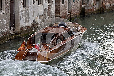 Wooden retro boat taxi in Venice on a summer day Editorial Stock Photo
