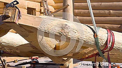 Wooden roof during the early stages of construction in a sunny day. Clip. Bottom view of a builder worker with crane Stock Photo