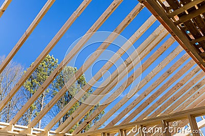 A wooden roof framework was constructed from trusses during the construction of a new beam stick home Stock Photo