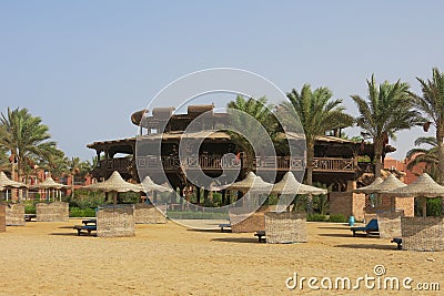 Wooden round building on the beach by the Red Sea. Atypical shape restaurant in Egypt. Exterior view of a pub made of natural Stock Photo