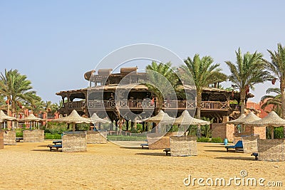 Wooden round building on the beach by the Red Sea. Atypical shape restaurant in Egypt. Exterior view of a pub made of natural Stock Photo